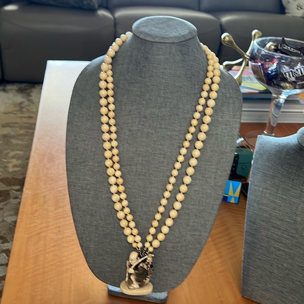 Ivory, double stranded beaded necklace with a little China man statue